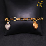 Pulsera con dije de corazón en tres tonos de oro de 14 kt