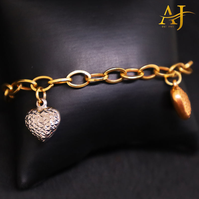 Pulsera con dije de corazón en tres tonos de oro de 14 kt